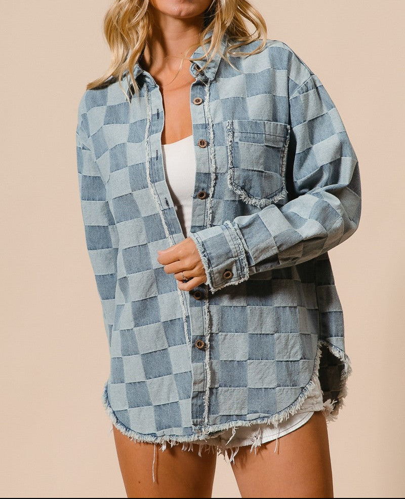 Woman wearing a checkered denim jacket on a beige background