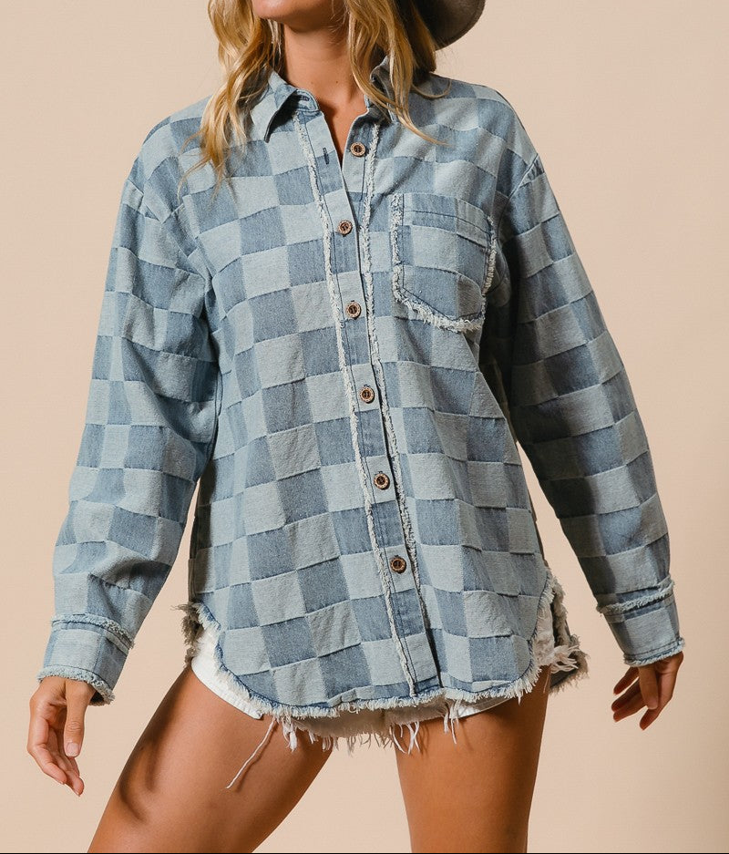 Woman wearing a checkered denim shirt and hat on a beige background