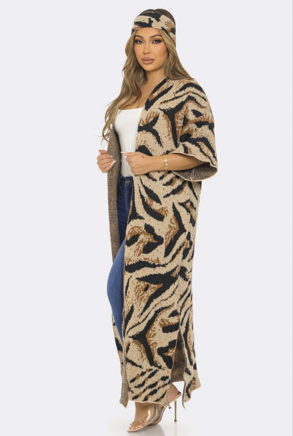 Woman wearing a tiger print kimono-style garment on a white background