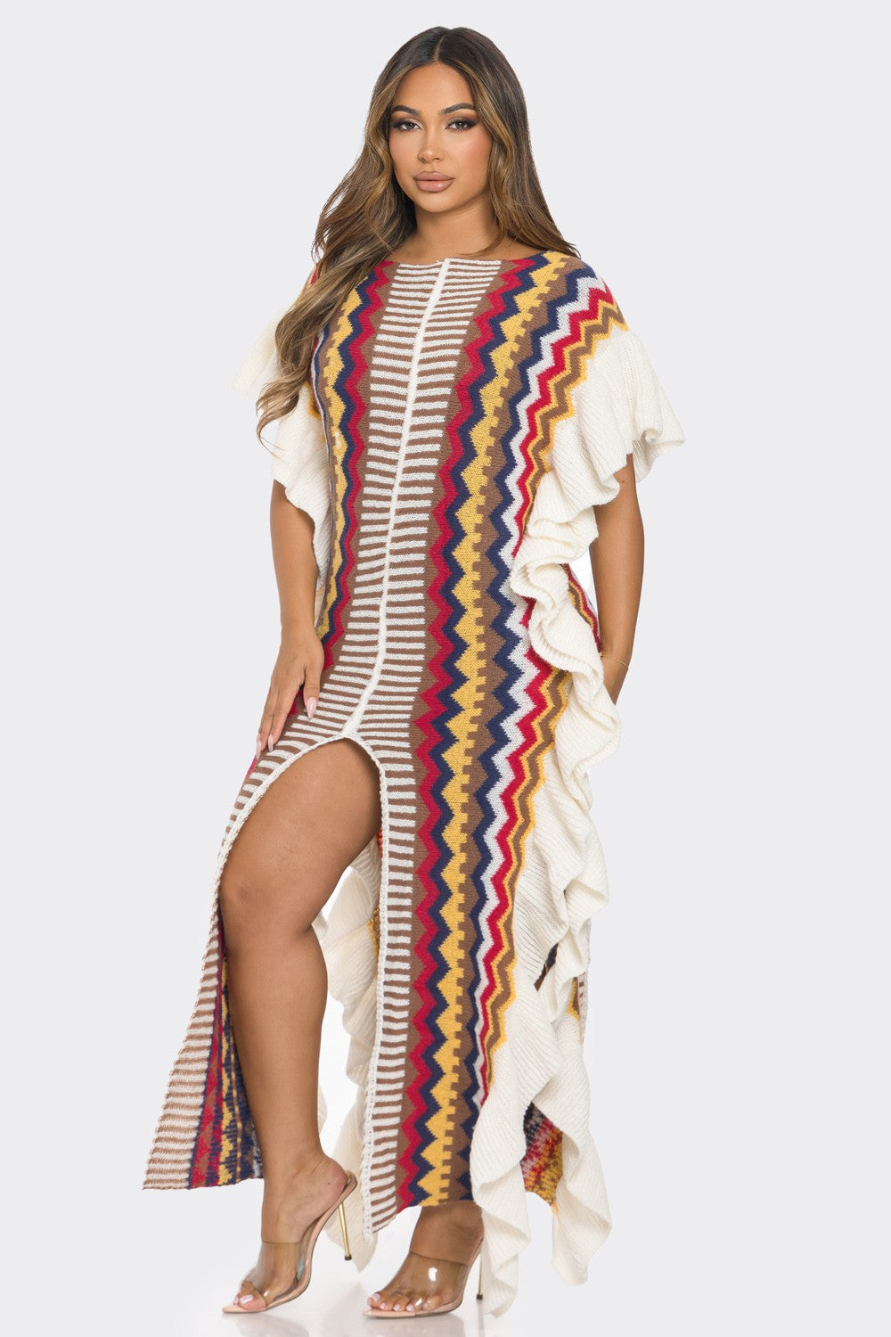 Woman wearing a colorful patterned dress with ruffled sleeves on a white background