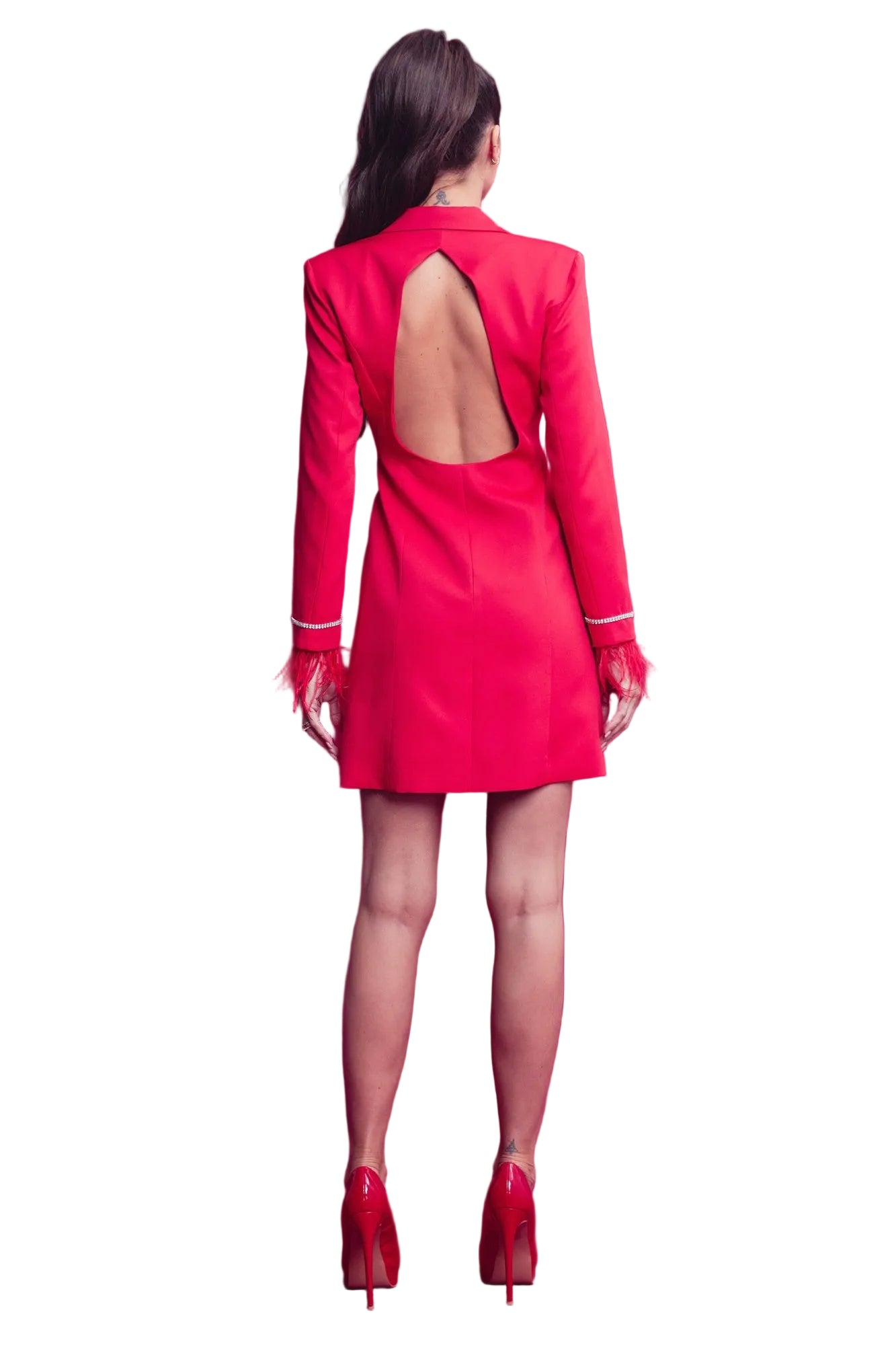 Woman wearing a red dress with an open back on a pink background