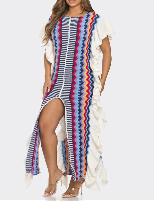 Woman wearing a colorful striped dress with a white top on a white background