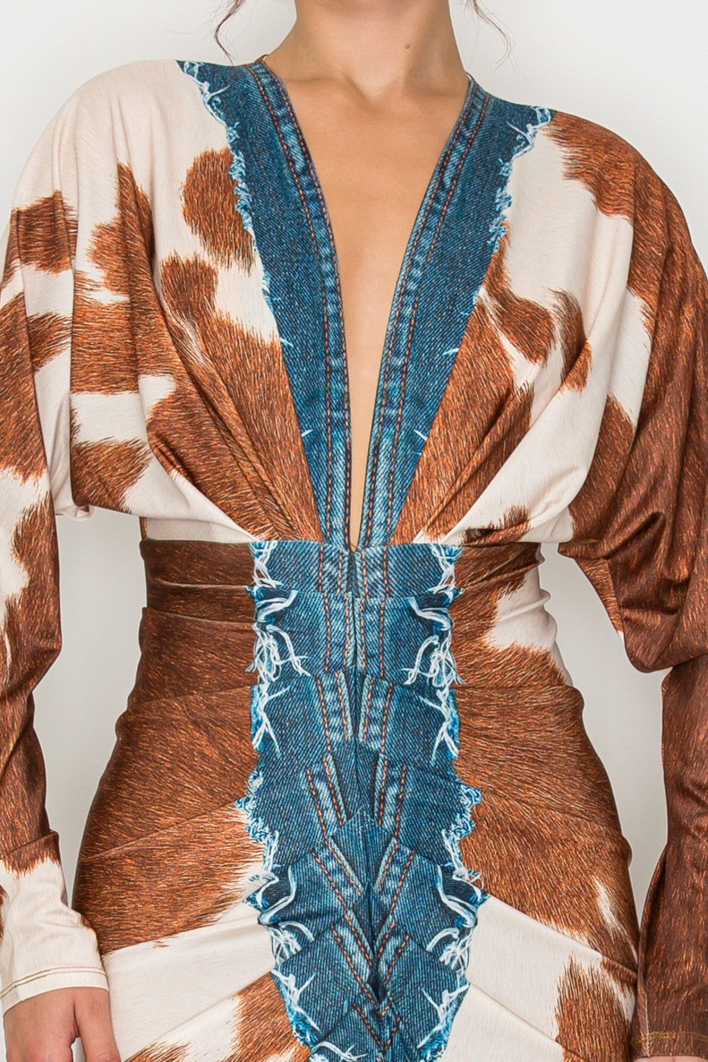 Person wearing a unique outfit with denim and cowhide pattern