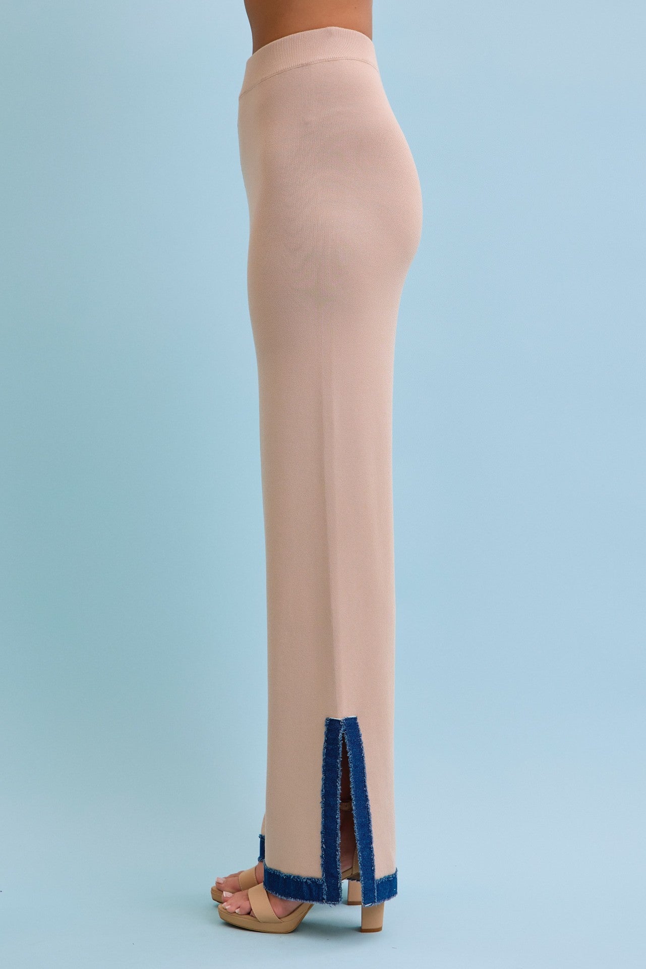 Beige pants with blue accents on a light blue background