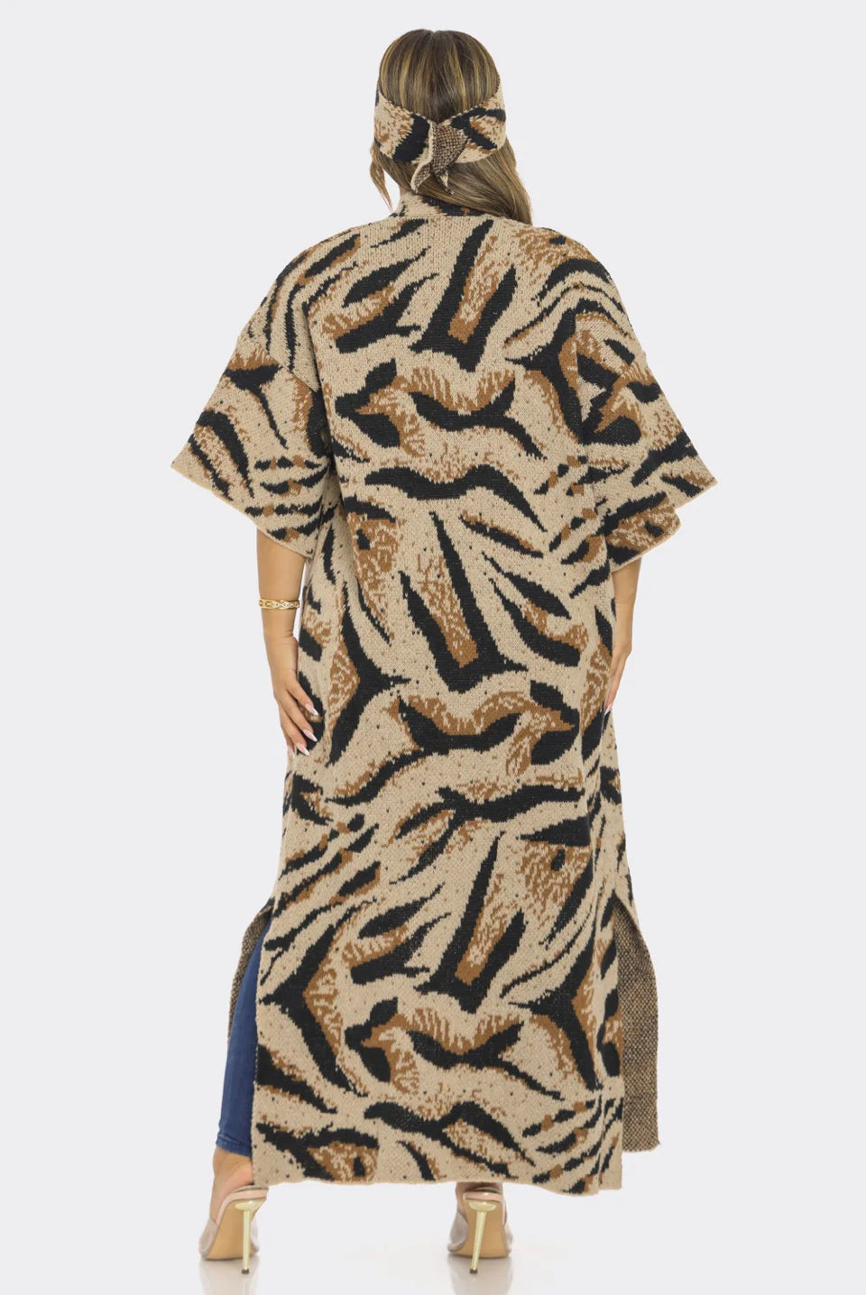 Person wearing a long, patterned dress with a white background